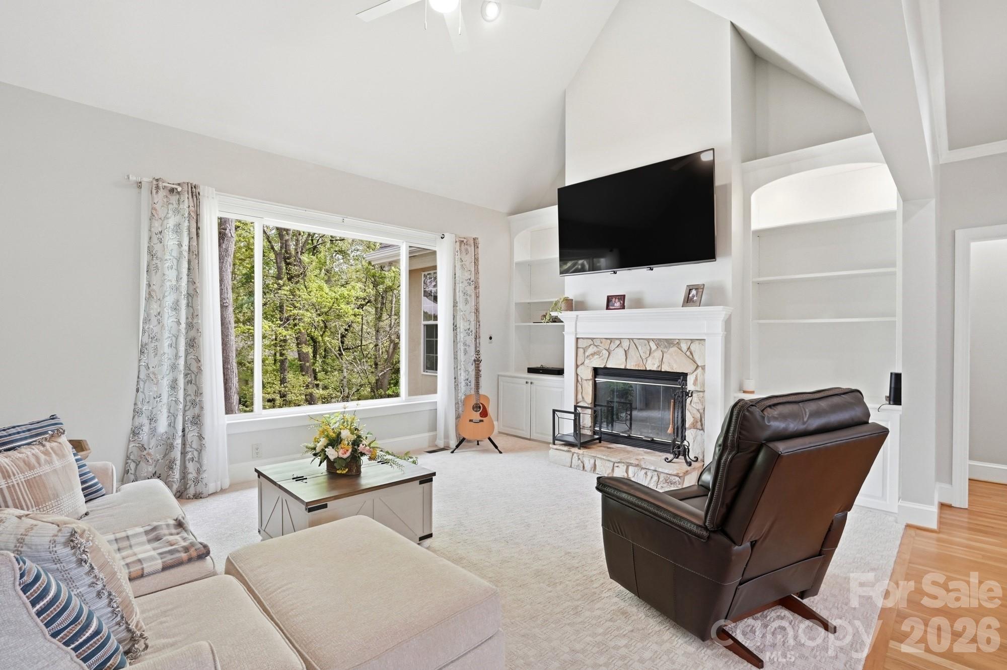 11078 Deep Cove Drive Tega Cay, SC 29708 - Photo 9 of 46 a living room with a fireplace furniture and a flat screen tv