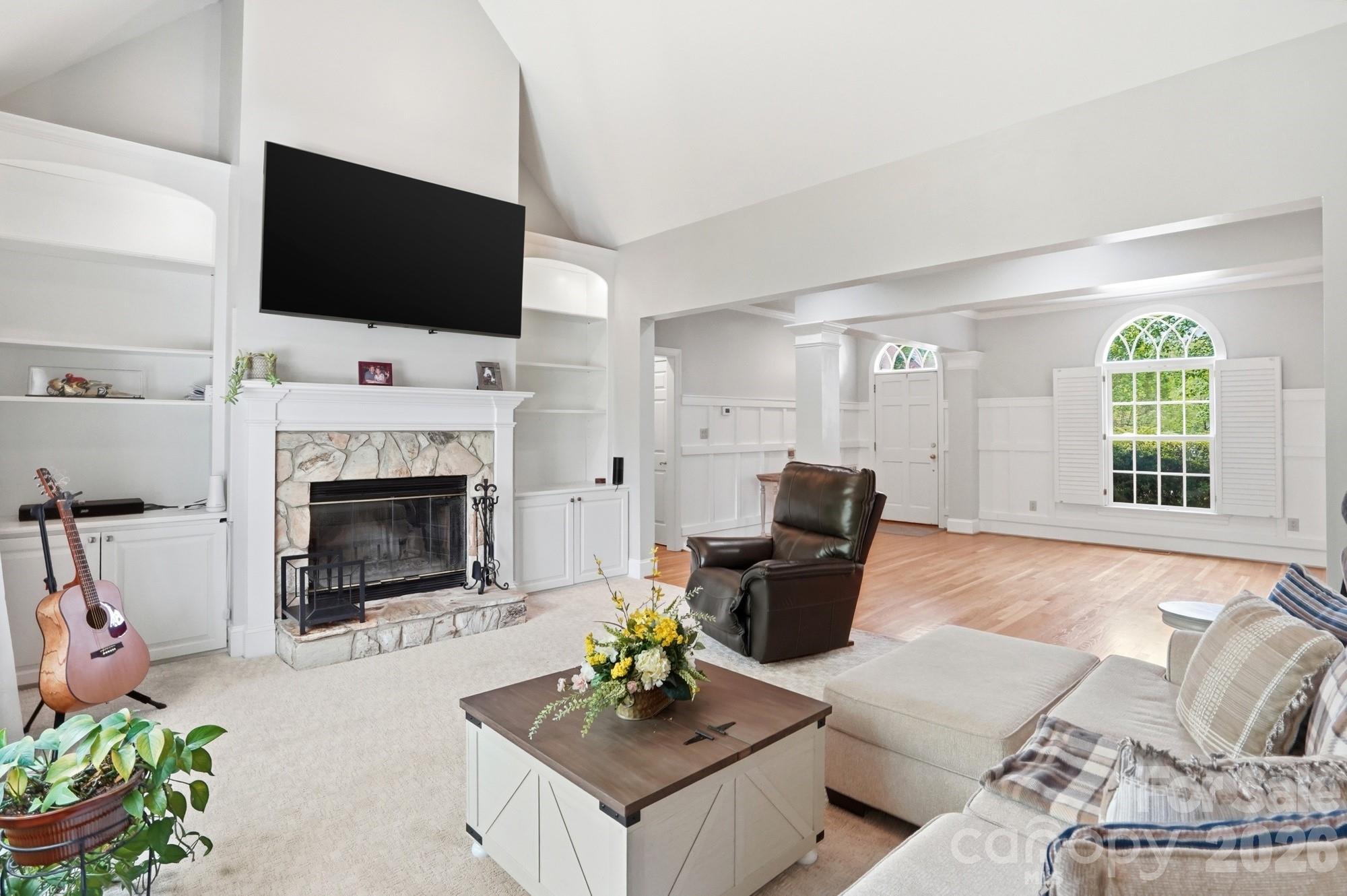 11078 Deep Cove Drive Tega Cay, SC 29708 - Photo 10 of 46 a living room with furniture a fireplace and a flat screen tv