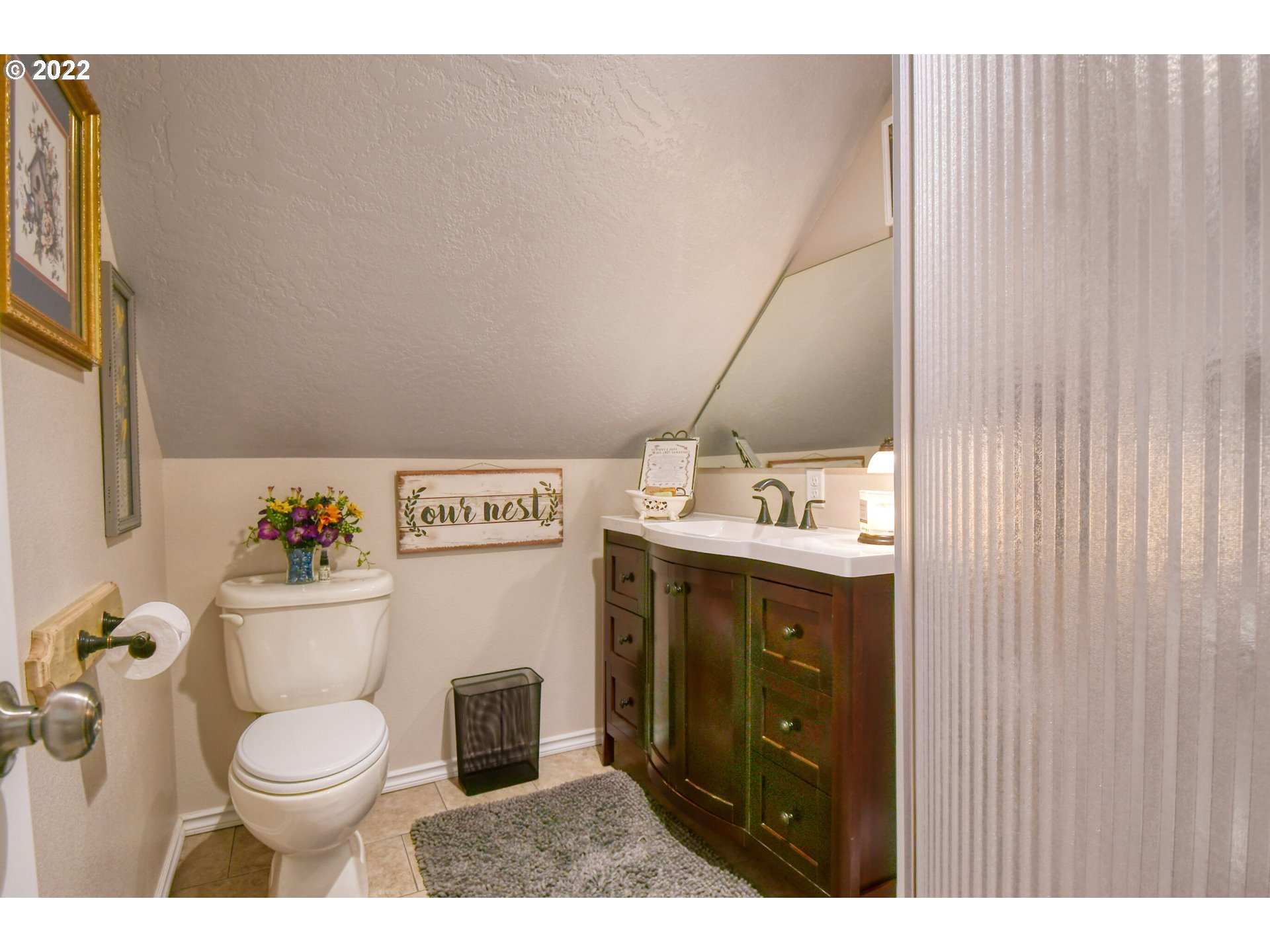 33104 Stage Gulch Road Stanfield, OR 97875 - Photo 23 of 32 a bathroom with a granite countertop toilet sink and mirror