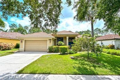 a front view of a house with a yard and potted plants