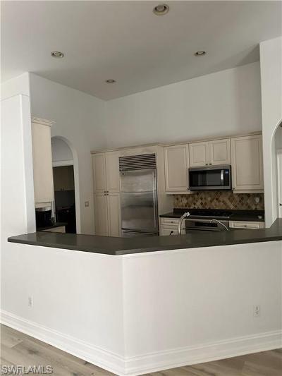 14852 Indigo Lakes Circle Naples, FL 34119 - Photo 3 of 9 a view of a kitchen with a sink and dishwasher a refrigerator with white cabinets