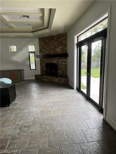 14852 Indigo Lakes Circle Naples, FL 34119 - Photo 4 of 9 a view of empty room with a fireplace
