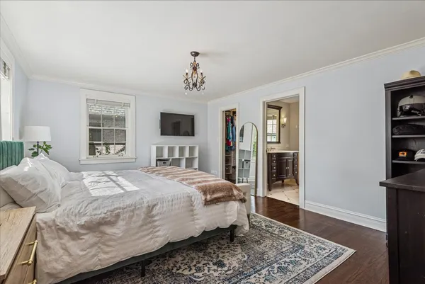 a bedroom with a large bed and a window