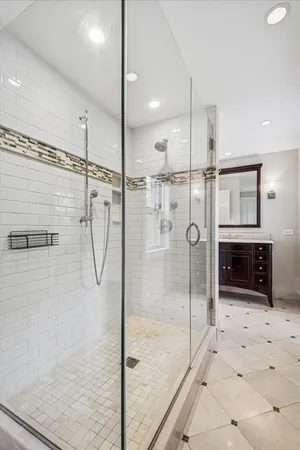 a bathroom with a glass shower door and a sink
