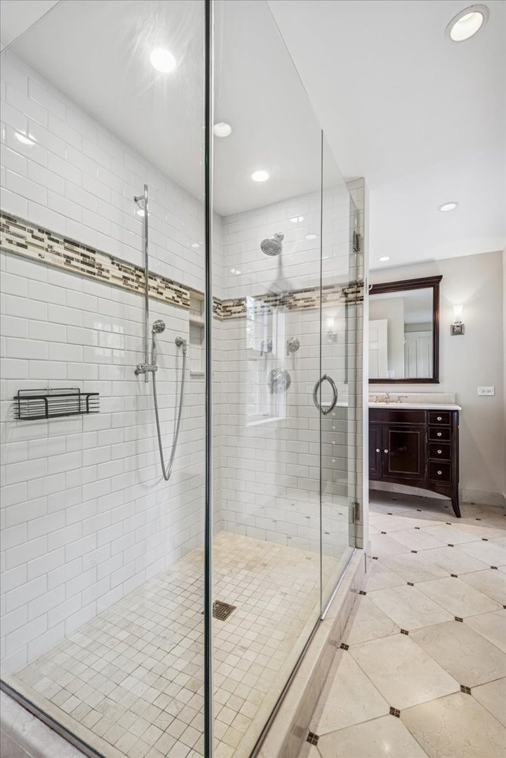 526 Orchard Lane Winnetka, IL 60093 - Photo 16 of 29 a bathroom with a glass shower door and a sink