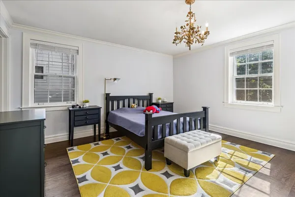 a bedroom with furniture and a window