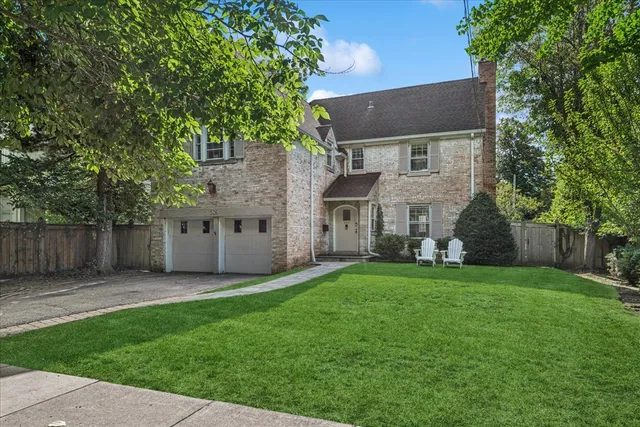 front view of a house with a yard and a trees