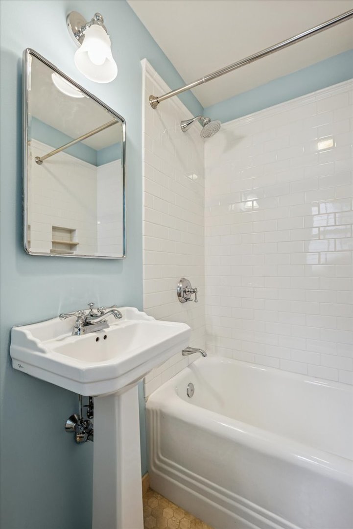 526 Orchard Lane Winnetka, IL 60093 - Photo 21 of 29 a bathroom with a sink a mirror a bathtub and shower