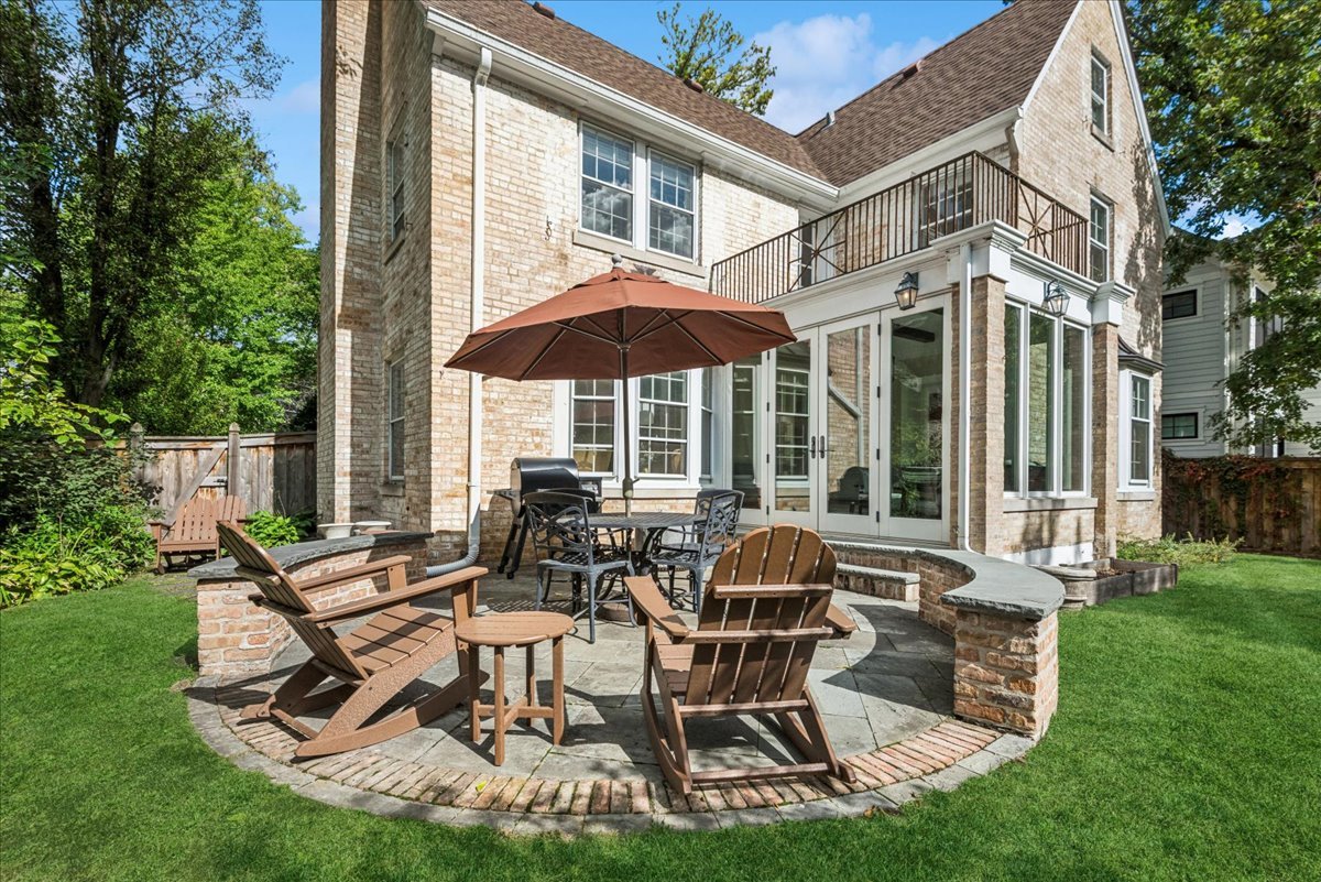 526 Orchard Lane Winnetka, IL 60093 - Photo 23 of 29 a view of a house with backyard sitting area and garden
