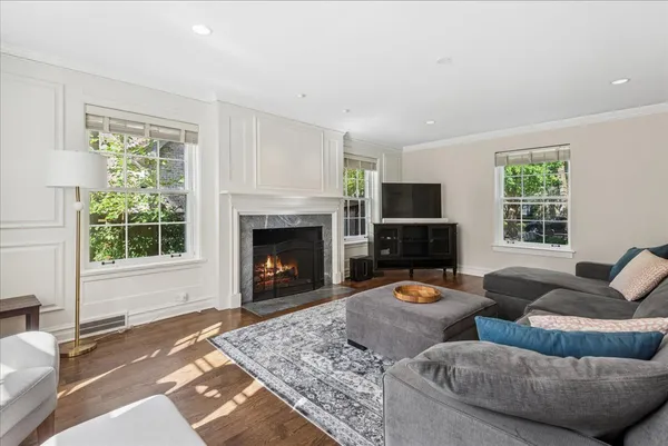 a living room with furniture flat screen tv and a fireplace