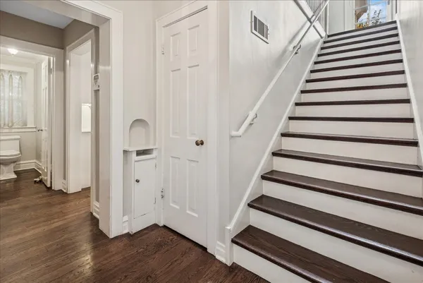 a view of entryway with wooden floor and stairs