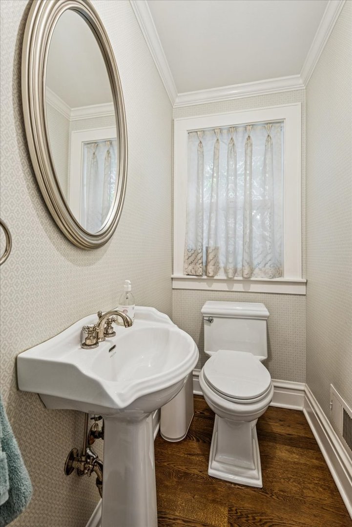 526 Orchard Lane Winnetka, IL 60093 - Photo 6 of 29 a bathroom with a sink a toilet and a mirror