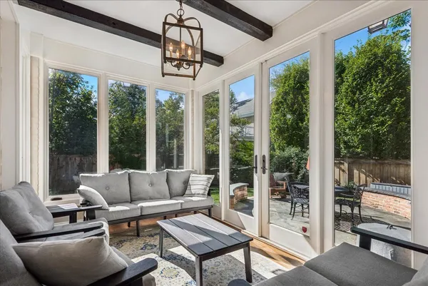 a living room with furniture and a chandelier
