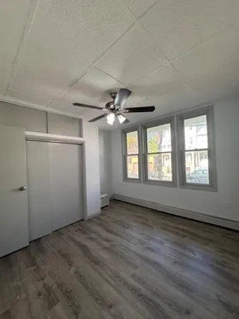 a view of an empty room and wooden floor