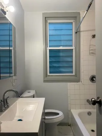 a kitchen with a sink a window and cabinets