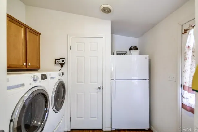 a white refrigerator freezer and a stove sitting inside of a kitchen