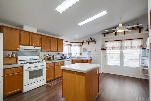 a kitchen with cabinets wooden floor and a sink