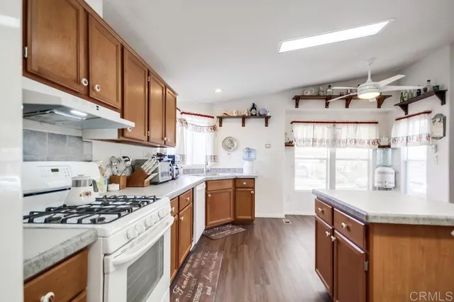 a kitchen with a stove a sink and a refrigerator