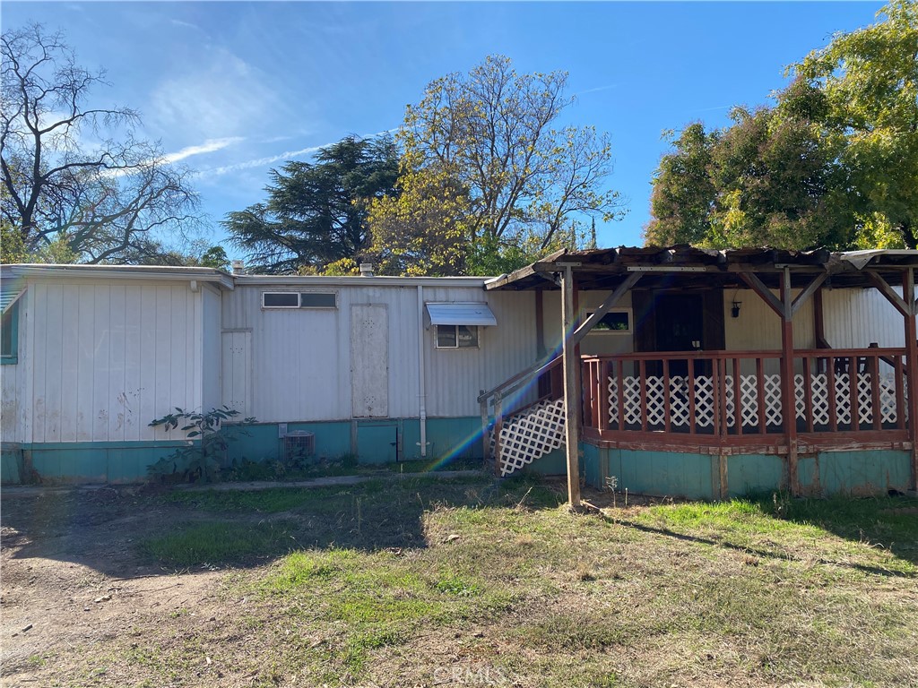 a view of a wooden house with a yard