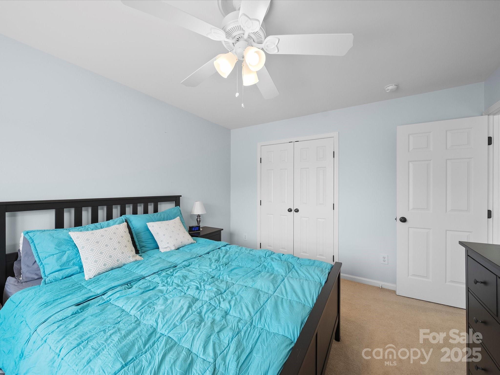1151 Gower Street Fort Mill, SC 29708 - Photo 27 of 40 a bedroom with a large bed and a chandelier fan