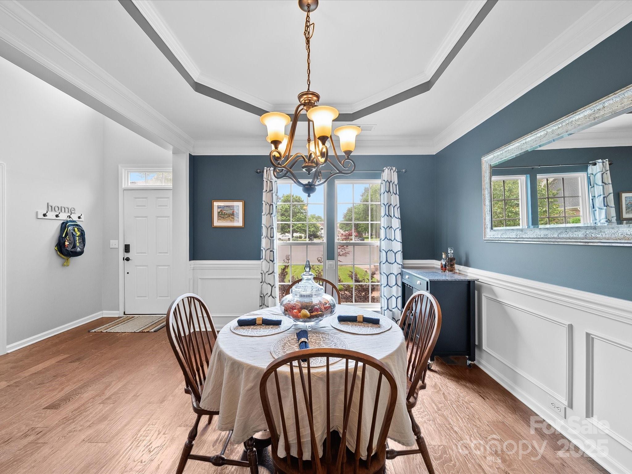 1151 Gower Street Fort Mill, SC 29708 - Photo 4 of 40 a view of a dining room with furniture a chandelier and wooden floor