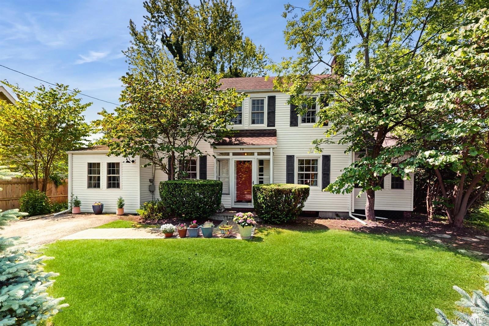 a front view of house with yard and outdoor seating