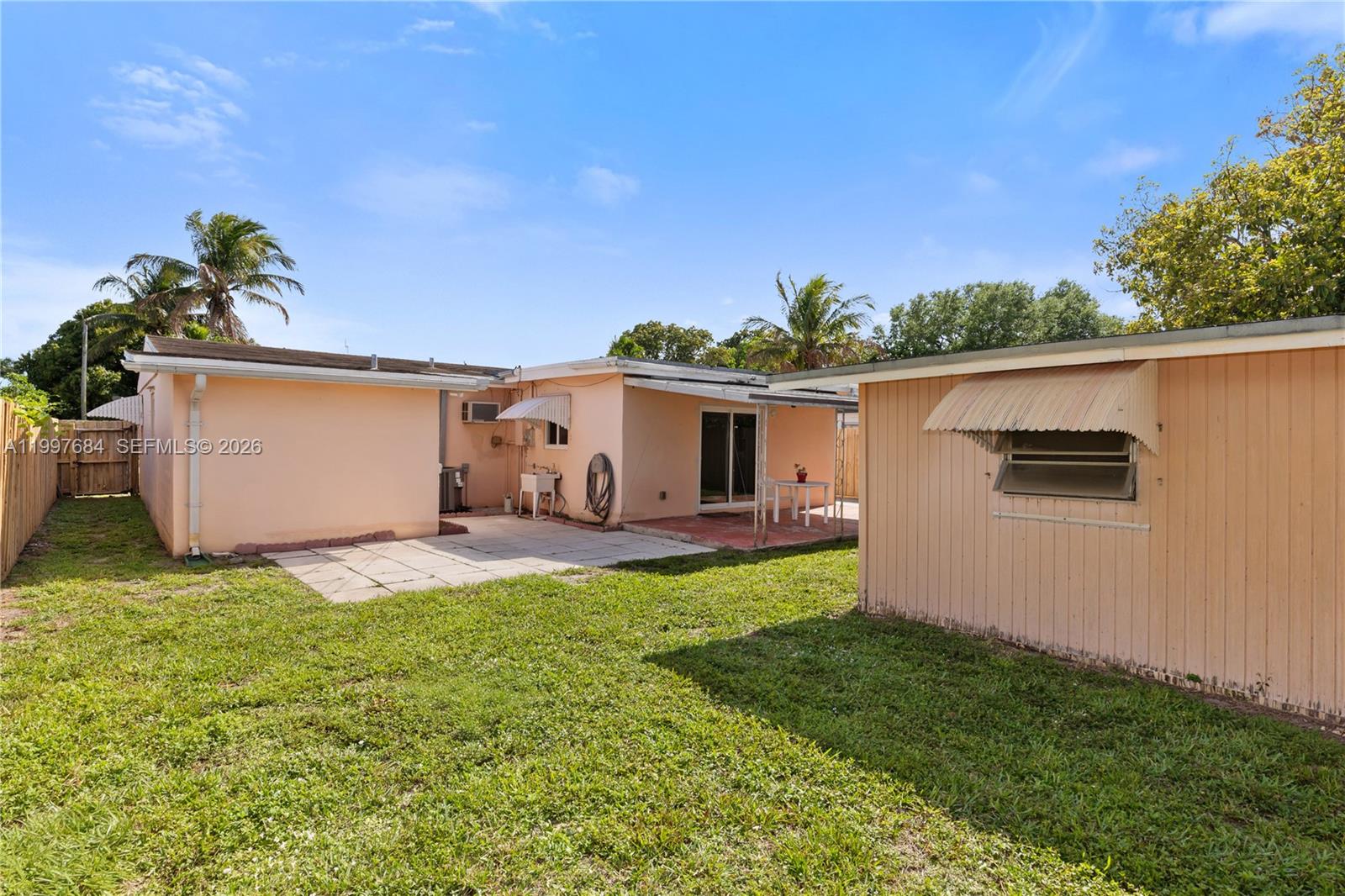 6441 Southwest 23rd Street Miramar, FL 33023 - Photo 2 of 31 A large fenced in yard with a shed