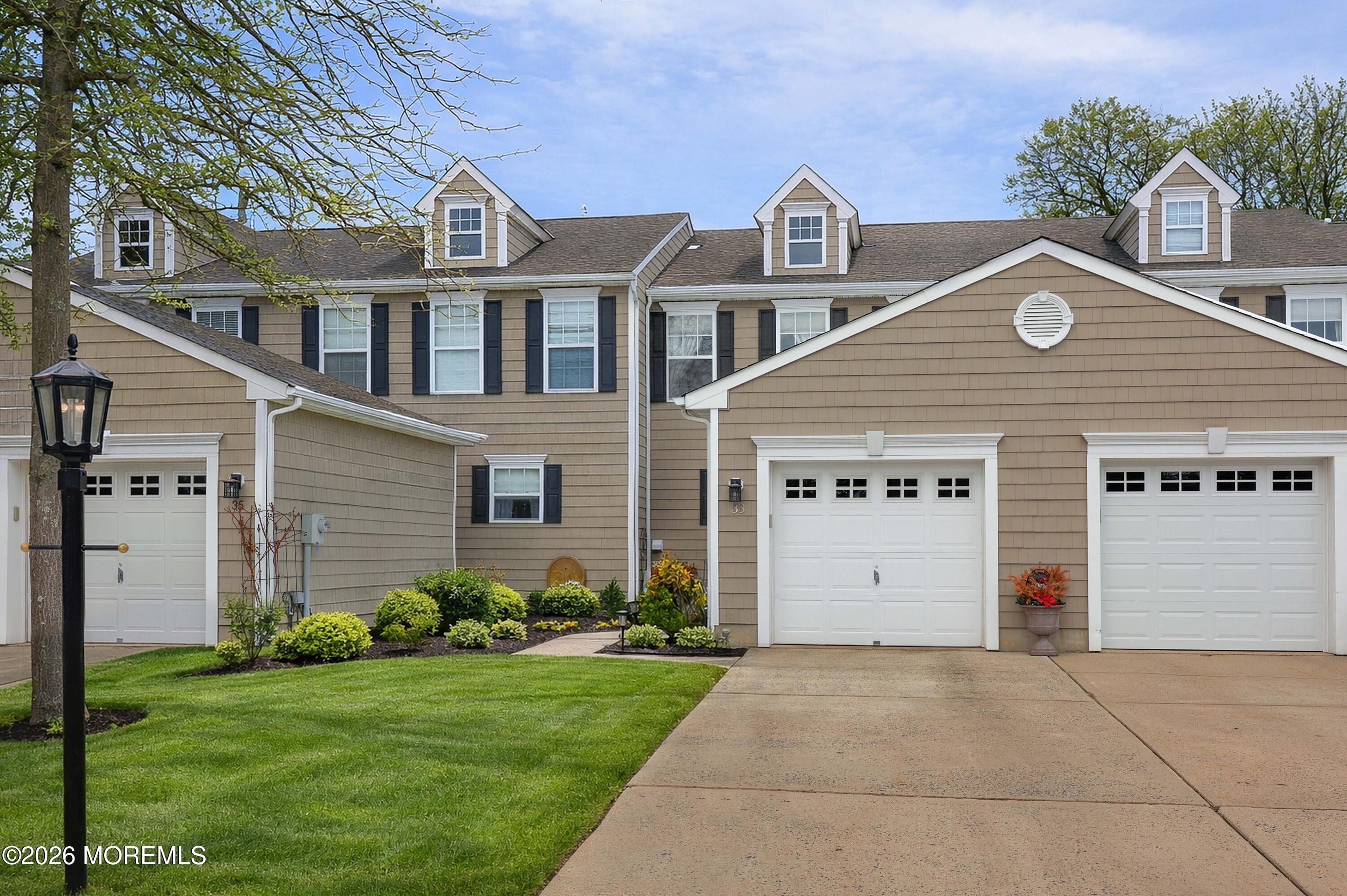 a front view of a house with a yard and garage