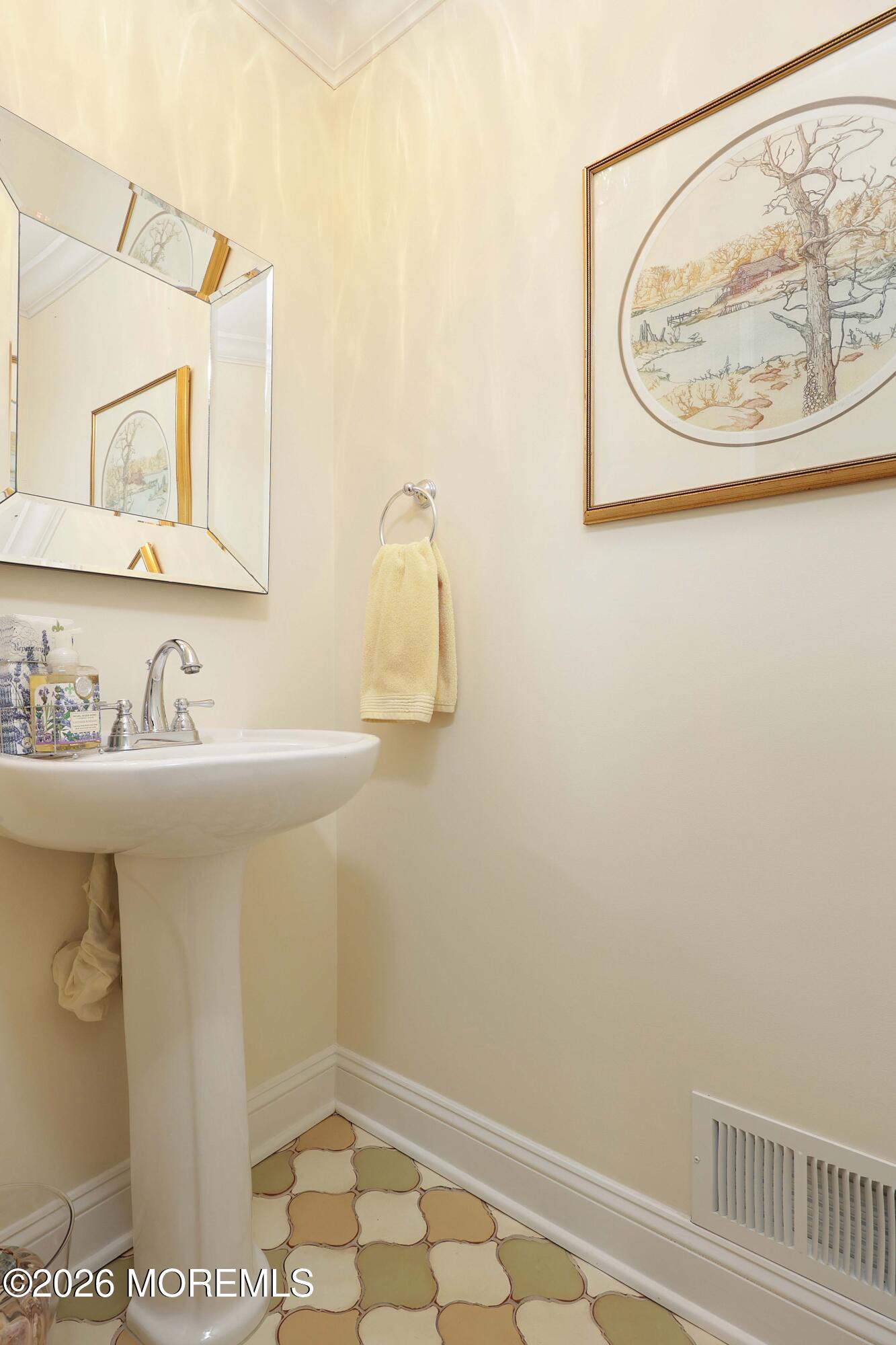 33 Chapin Avenue Red Bank, NJ 07701 - Photo 29 of 33 a bathroom with a sink and a mirror