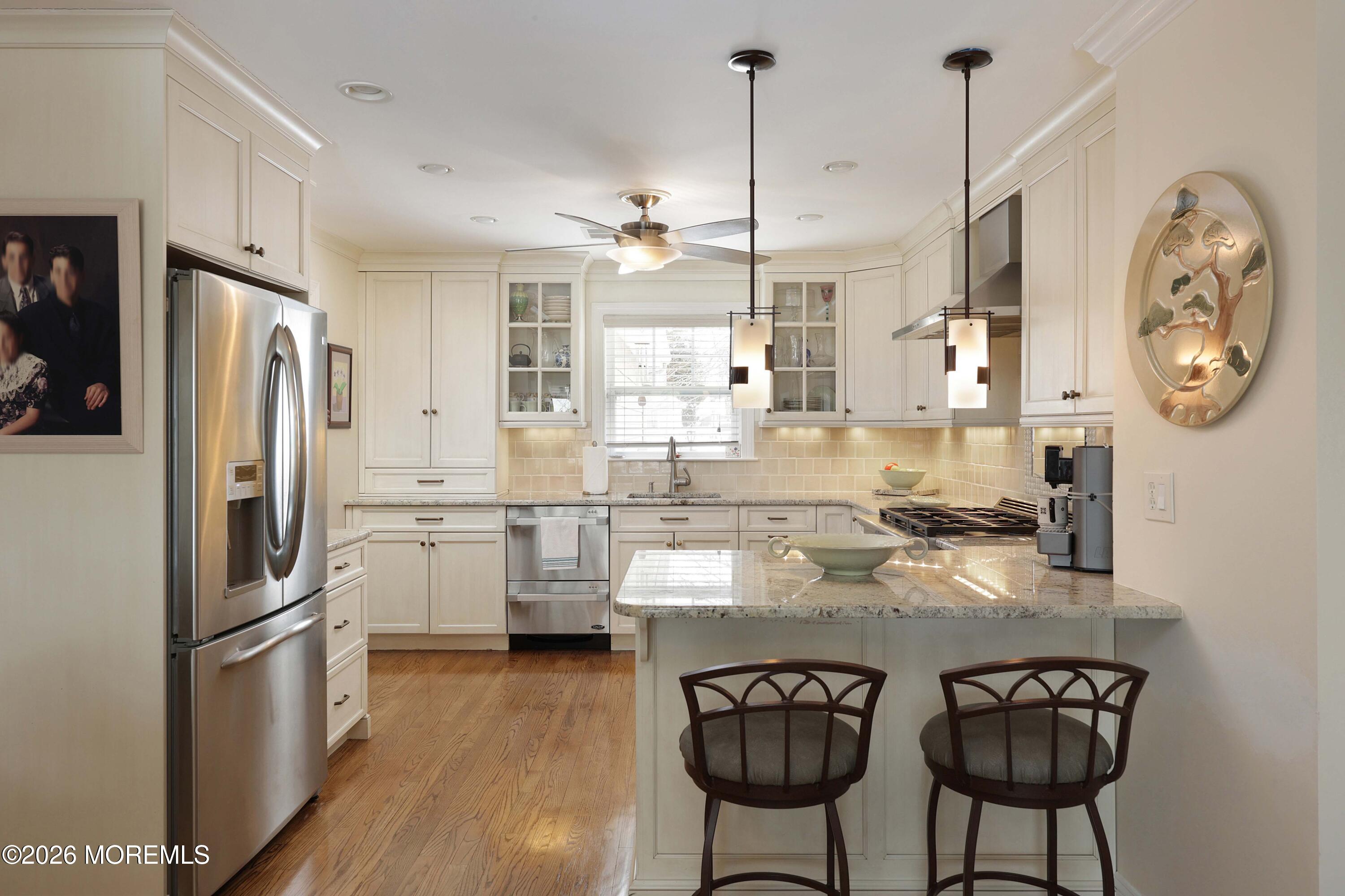 33 Chapin Avenue Red Bank, NJ 07701 - Photo 6 of 33 a kitchen with stainless steel appliances granite countertop a sink a stove a refrigerator and island with wooden floor