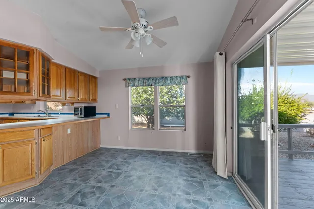 a kitchen with a refrigerator a stove top oven a sink and cabinets