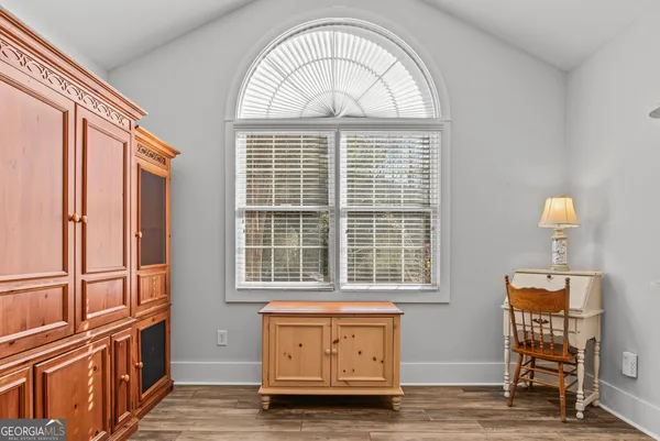 an empty room with windows cabinet and front door
