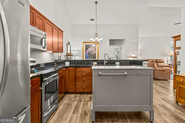 a kitchen with a sink stove and cabinets