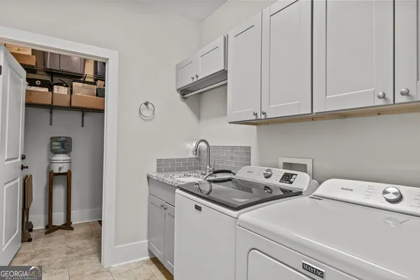 a view of storage and utility room with washer and dryer