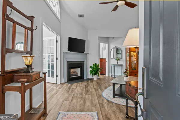a living room with furniture a fireplace and a flat screen tv