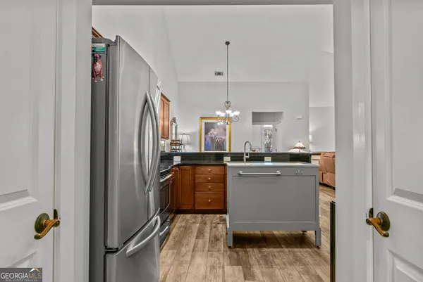 a kitchen with stainless steel appliances granite countertop a refrigerator and a sink