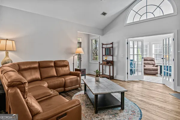 a living room with furniture and a wooden floor
