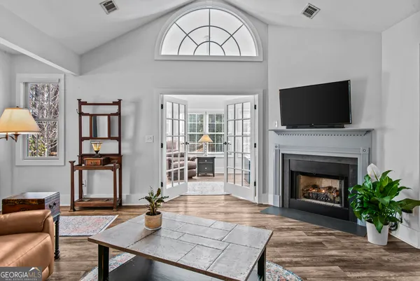 a living room with furniture a fireplace and a flat screen tv