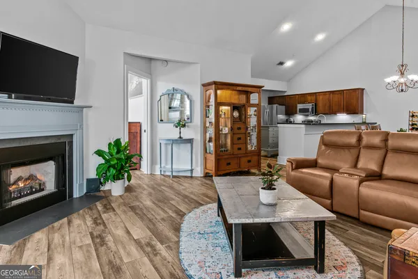 a living room with furniture a flat screen tv and a fireplace