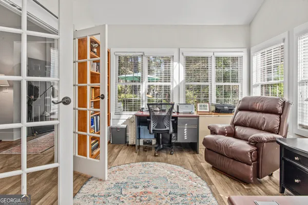 a living room with furniture a rug and a large window