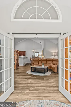 a living room with furniture and a wooden floor