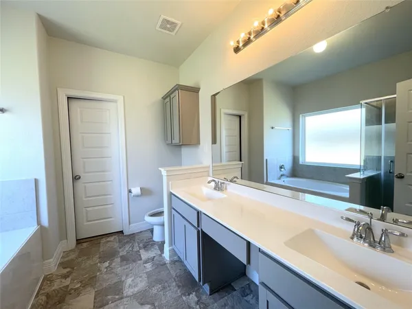 a bathroom with a sink double vanity and a mirror