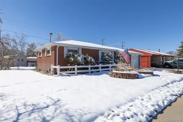 a view of a house with snow on the road