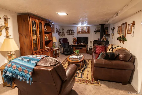 a living room with furniture a flat screen tv and a lamp