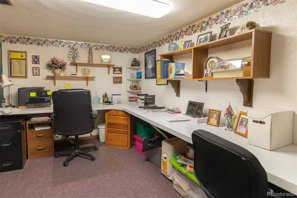 a work room with furniture and a flat screen tv