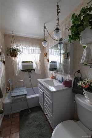 a bathroom with a toilet a sink and mirror