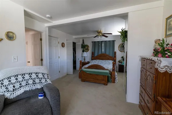 a bedroom with a bed and a car