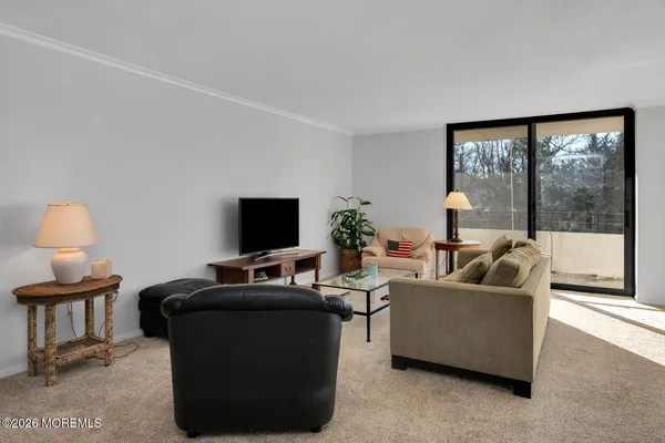 a kitchen with stainless steel appliances granite countertop a stove top oven a sink dishwasher and a refrigerator with wooden cabinets