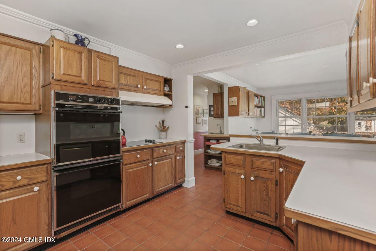 242 Taconic Road Greenwich, CT 06831 - Photo 16 of 37 a kitchen with stainless steel appliances granite countertop a refrigerator a sink dishwasher a stove and white countertops with wooden floor