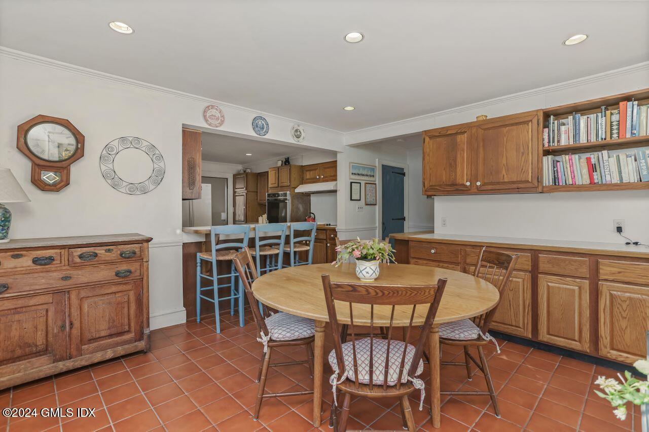 242 Taconic Road Greenwich, CT 06831 - Photo 18 of 37 a view of a kitchen with a dining table and chairs